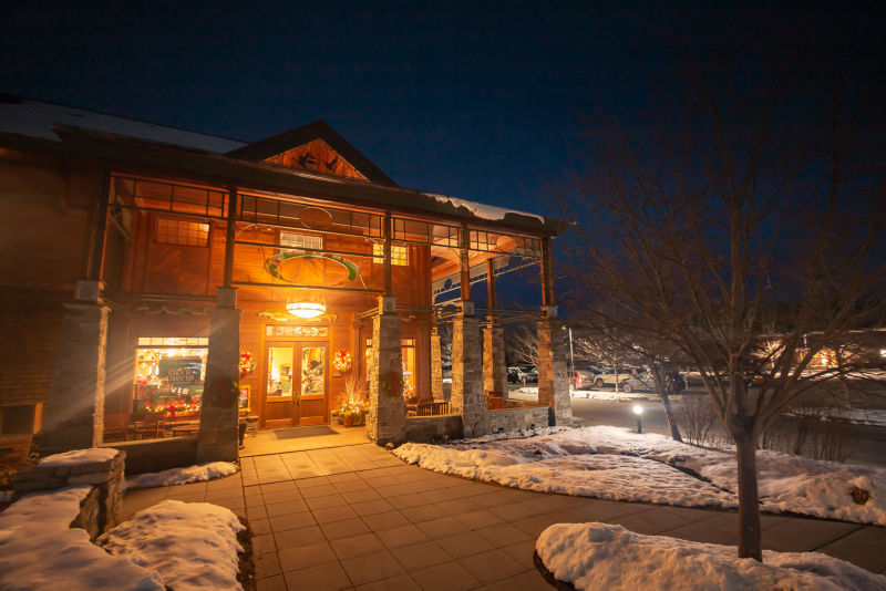 View of the Manchester Vermont Orvis Retail Store lit up at night.